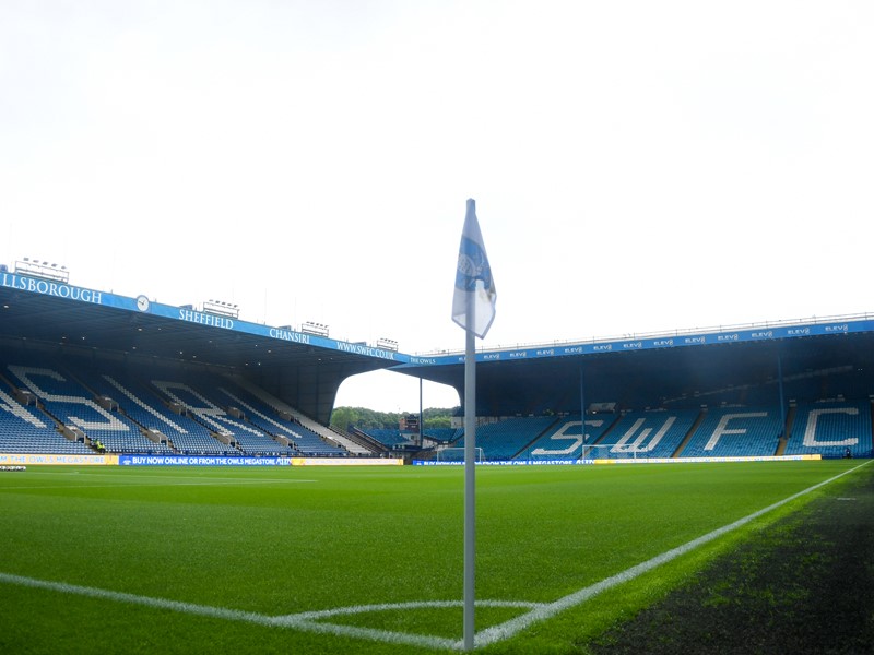 Picture of Sheffield Wednesday football pitch, at the edge, showing the corner flag and the seats in the background