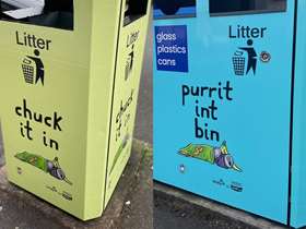 Three people lean on bright blue bin with 'purrit int bin' wording