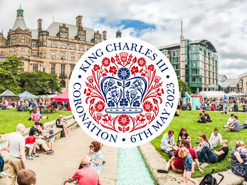 Peace Garden, Sheffield with people sat on the grass and the 'King Charles III Coronation' emblem over the top, infront of the Town Hall