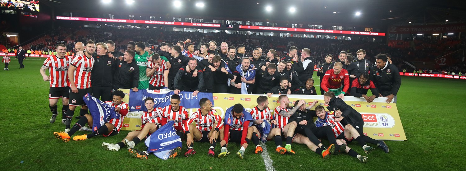 Sheffield United football players, huddled together for a picture on the pitch inside the stadium