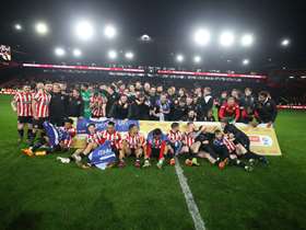 Sheffield United football players, huddled together for a picture on the pitch inside the stadium