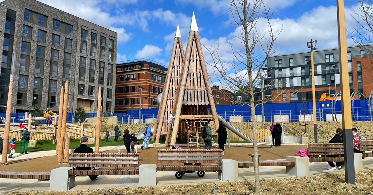 A view of Pound's Park on a sunny day with buildings in the background. 