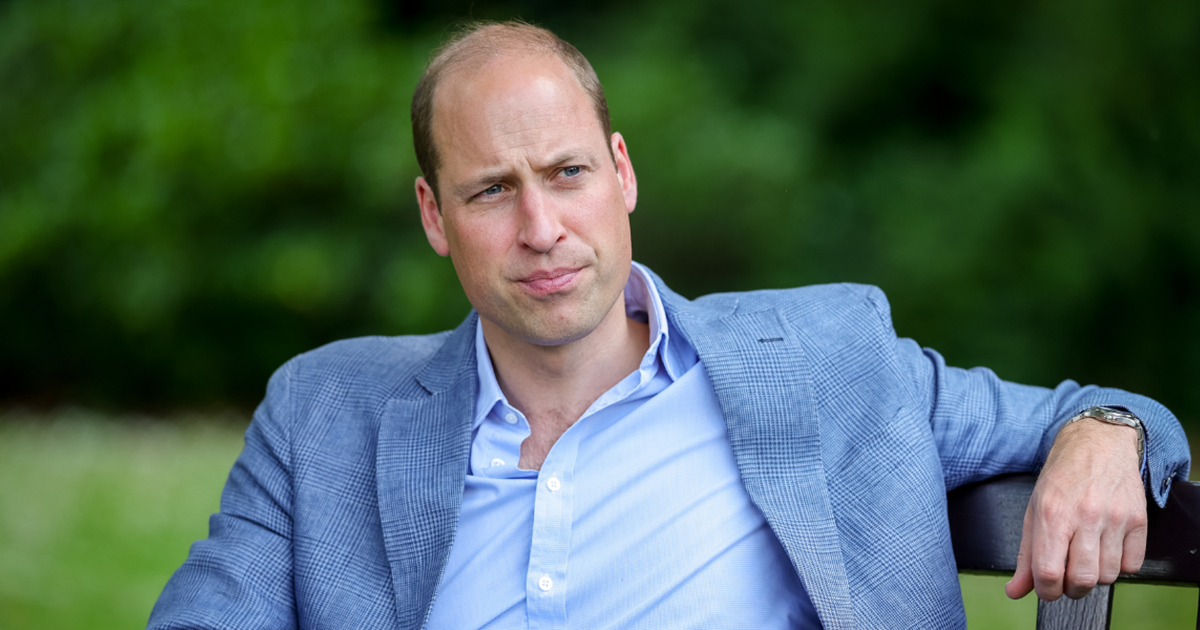 Prince William sat down on a bench wearing a blue shirt and darker blue blazer