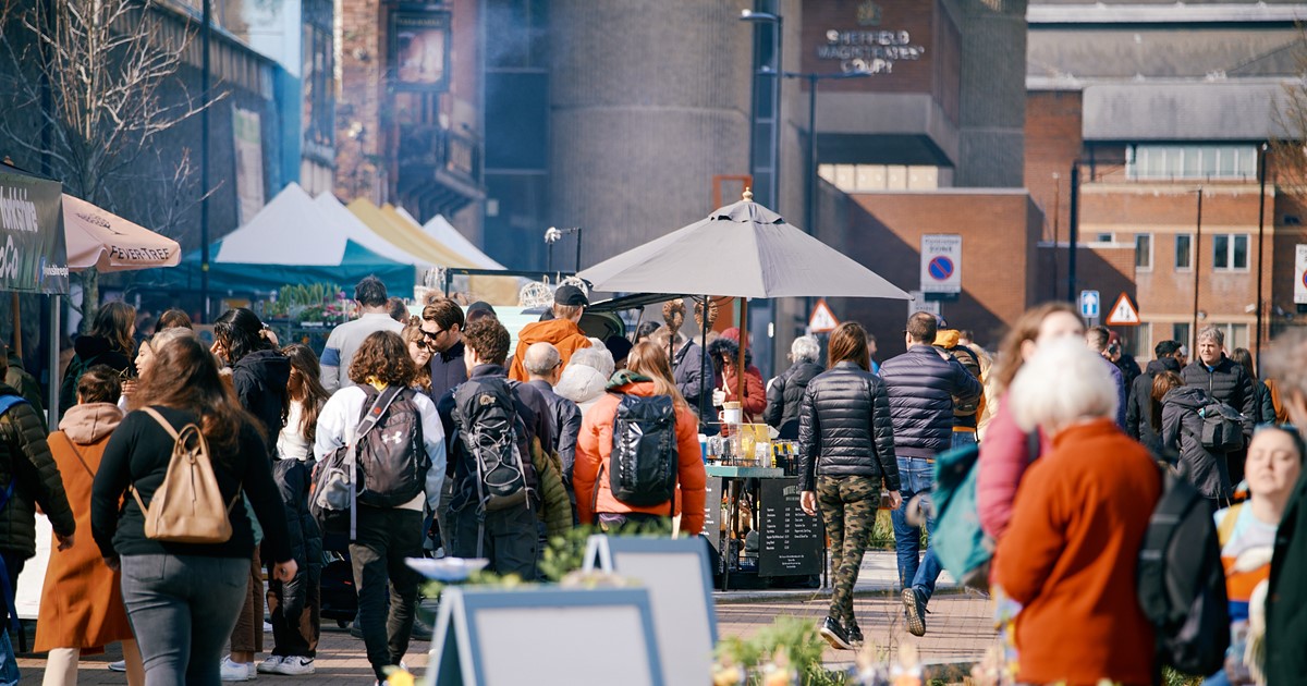 People walking through a city centre market