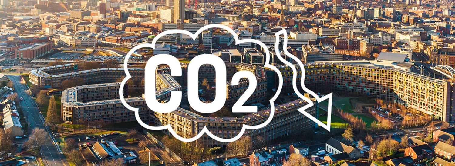 A drone shot of Sheffield city centre with a graphic over the top which says CO2 with a downward arrow.