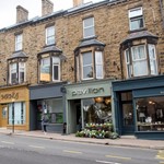 Council funding will empower communities to transform high streets A row of shops with flats above. The shopfronts are newly painted.