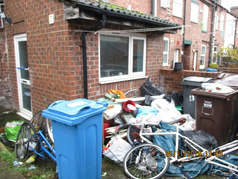 A home with piles of litter outside