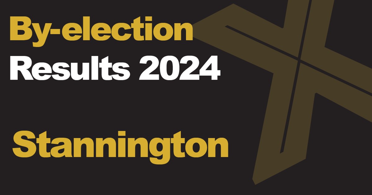 A dark coloured rectangle box with a large orange cross on the right handside, the text reads "Election results 2024 Stannington"