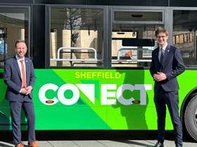 Cllr Ben Miskell and Cllr Tom Hunt standing in front of a green Sheffield Connect fully electric bus