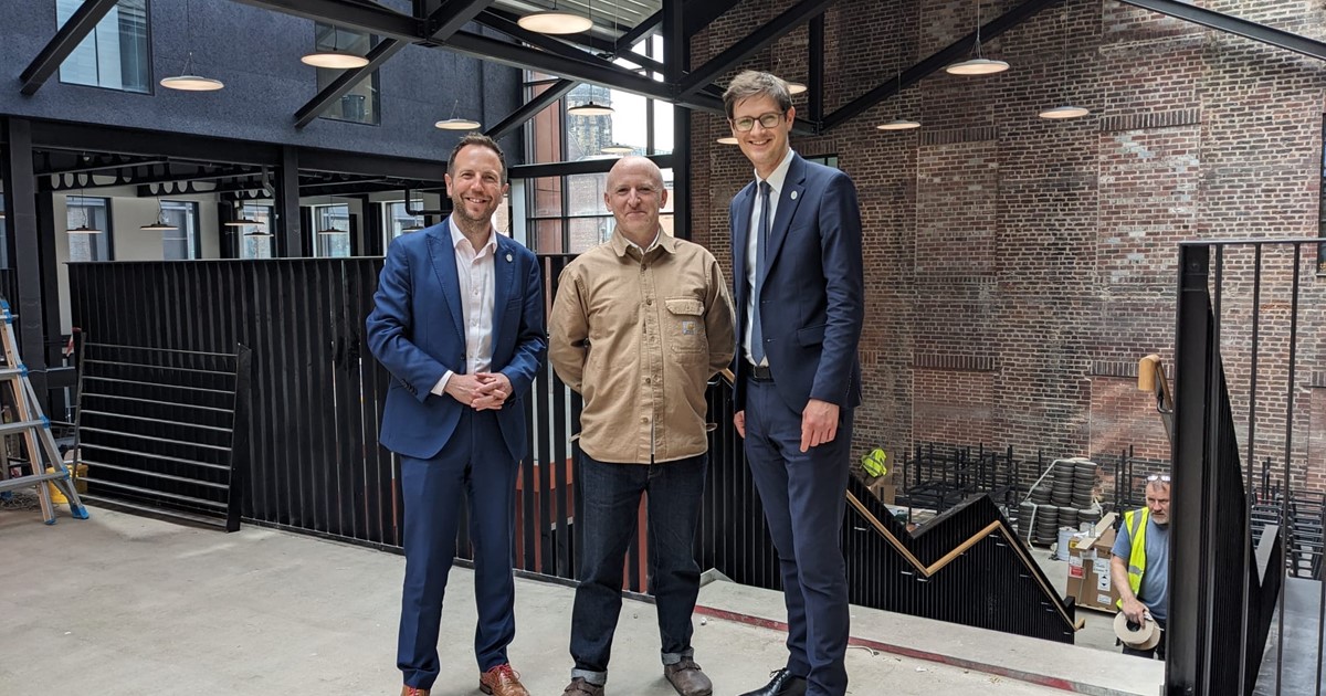 Cllr Ben Miskell, Matt Bigland and Cllr Tom Hunt stand on the first floor of Cambridge Street Collective food hall.