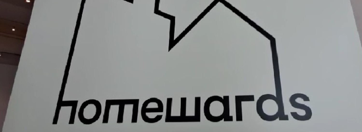 The Homewards logo, with the outline of housing, on a blank display baord