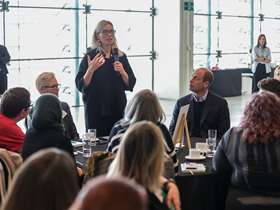 Chief Executive of Sheffield City Council Kate Josephs speaks into a microphone at a Homewards event in Sheffield's Millennium Gallery while attendees including HRH The Prince of Wales listen Chief Executive of Sheffield City Council Kate Josephs speaks into a microphone at a Homewards event in Sheffield's Millennium Gallery while attendees including HRH The Prince of Wales listen