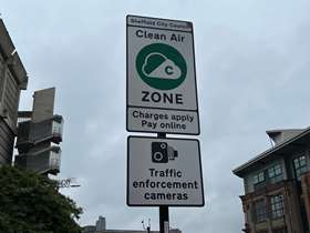 A road sign showing the start of the Clean Air Zone, underneath is another sign with a picture of a camera on it, underneath that are the words Traffic Enforcement Cameras A road sign showing the start of the Clean Air Zone, underneath is another sign with a picture of a camera on it, underneath that are the words Traffic Enforcement Cameras