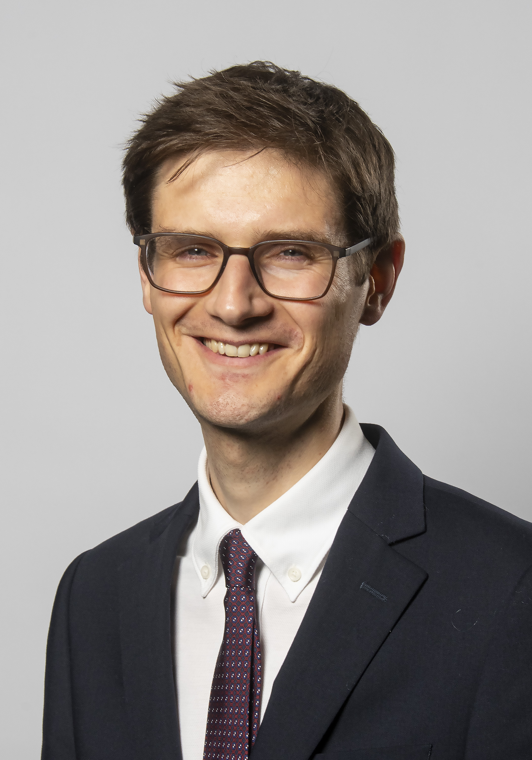 Sheffield City Council Leader, Cllr Tom Hunt, smiles at the camera, dressed in a suit and tie