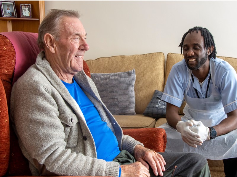 A carer and a person who is being cared for at home