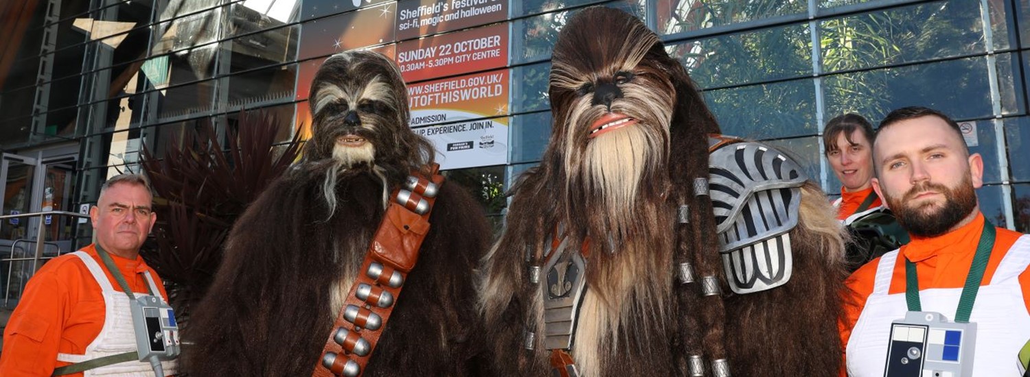People dressed as ghostbusters and star wars characters outside the Sheffield Winter Garden