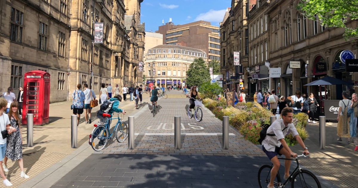 An artist impression of the pedestrianised Surrey Street with the Town Hall on the left, businesses on the right and people either walking or cycling along the middle of the picture