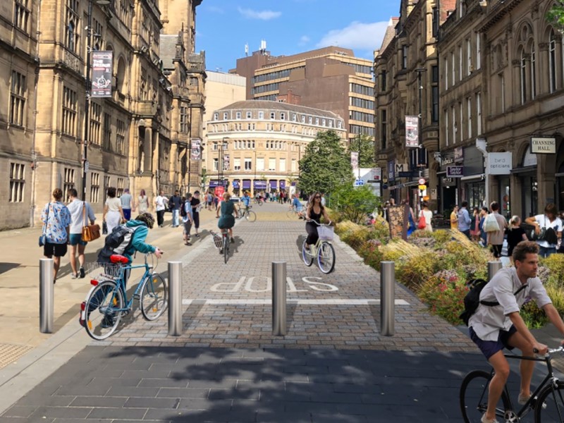 An artist impression of the pedestrianised Surrey Street with the Town Hall on the left, businesses on the right and people either walking or cycling along the middle of the picture