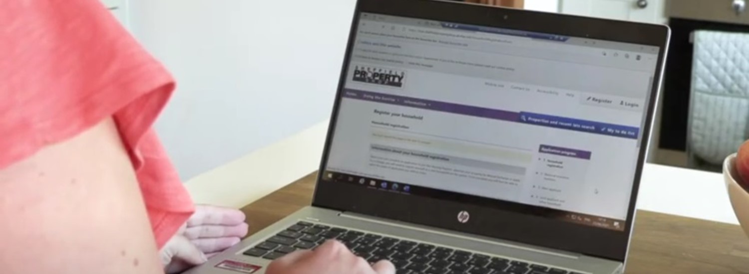 A member of the public vieweing the Sheffield Property Shop website on their laptop in their home