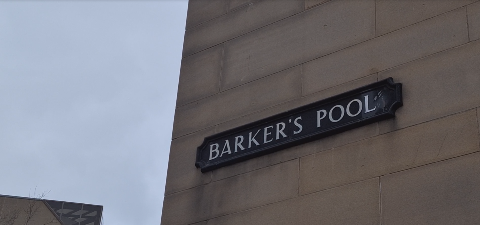 Barker's Pool sign on a beige building 