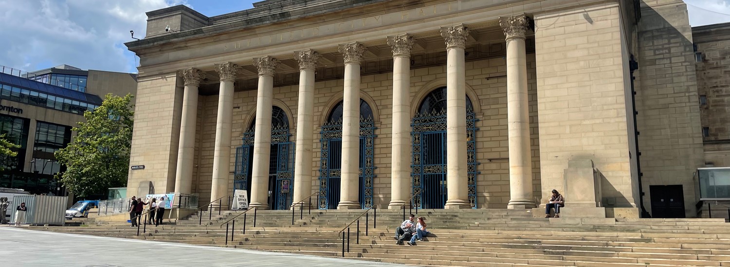 View of Sheffield City Hall from below with blue skies in the background