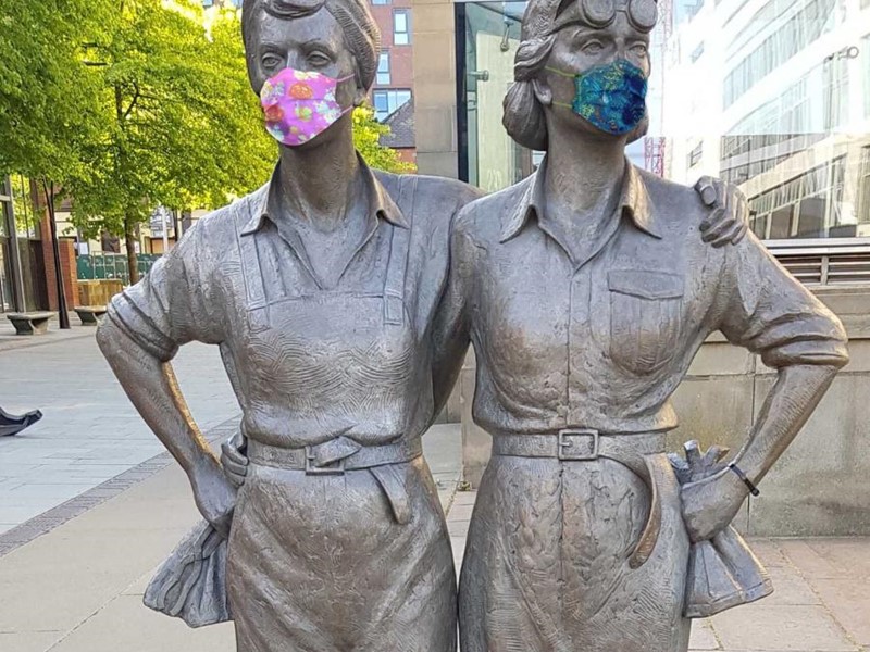 Women of Steel statue wearing masks