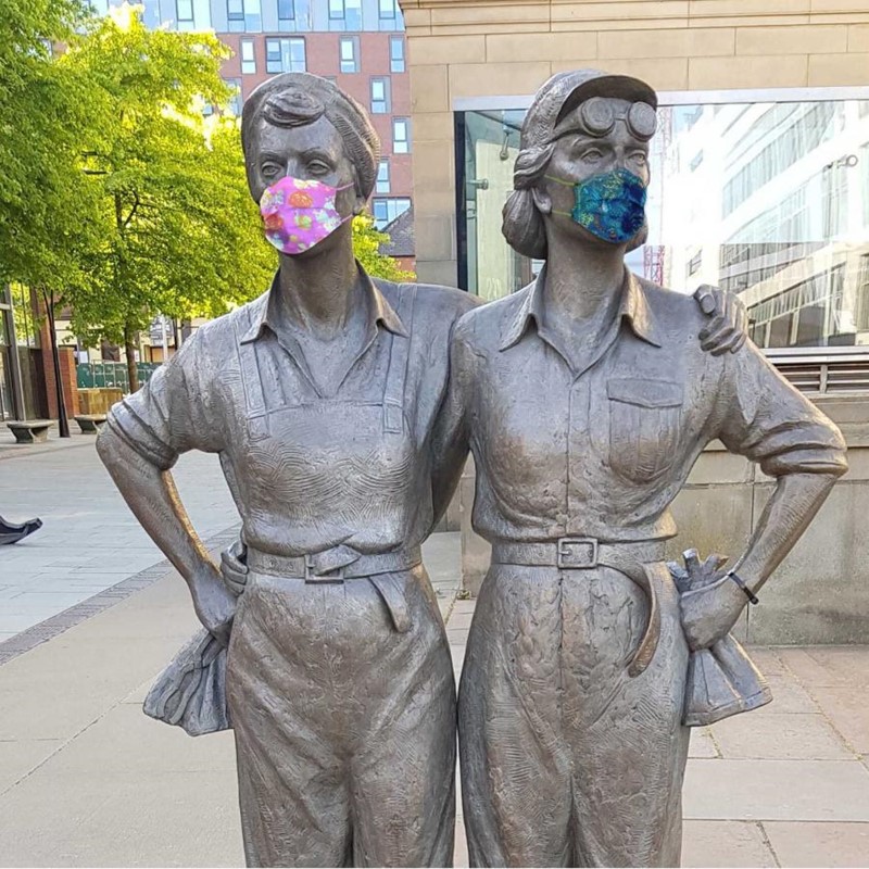 Women of Steel statue wearing masks