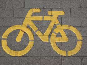 Yellow cycle path sign on a path