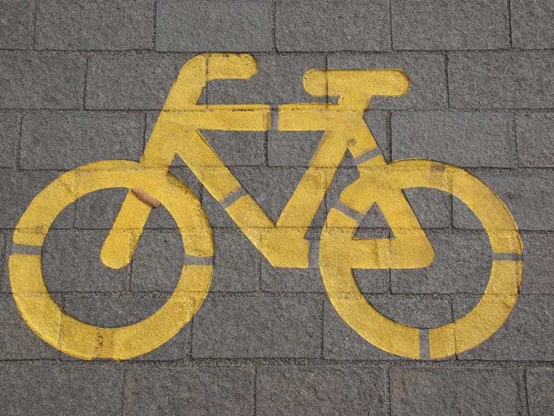 Yellow cycle path sign on a path