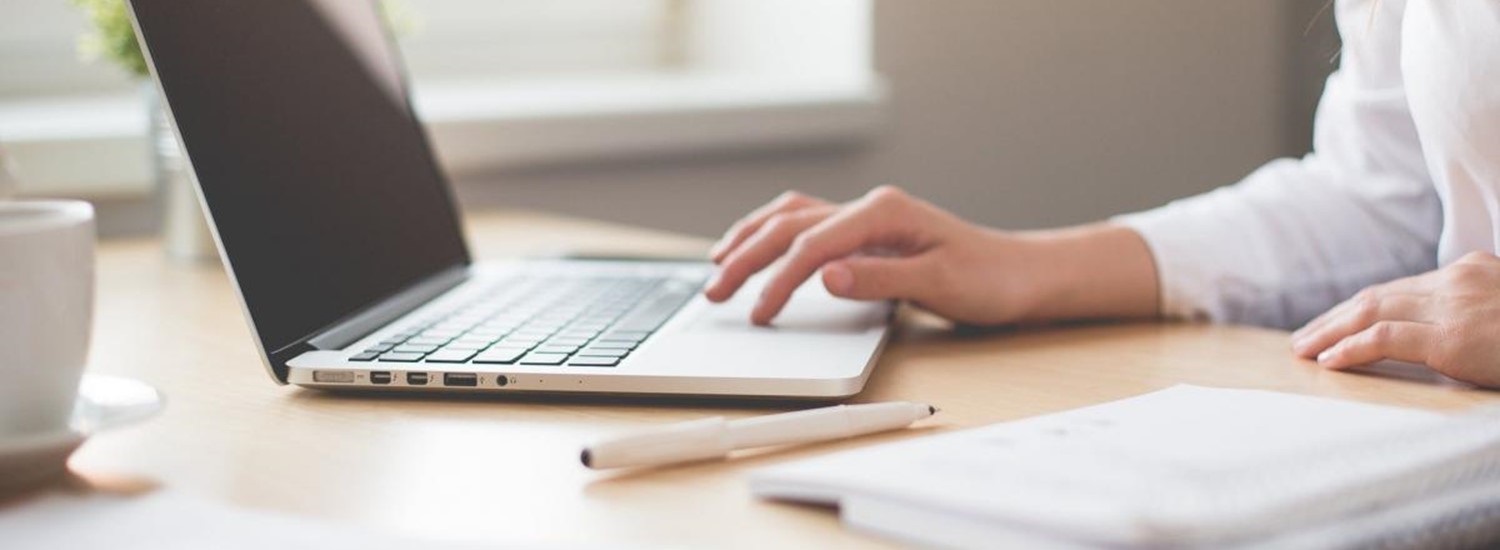 A person typing at laptop