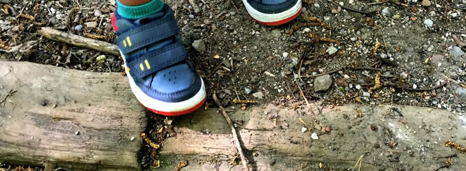 child's feet next to a kerb