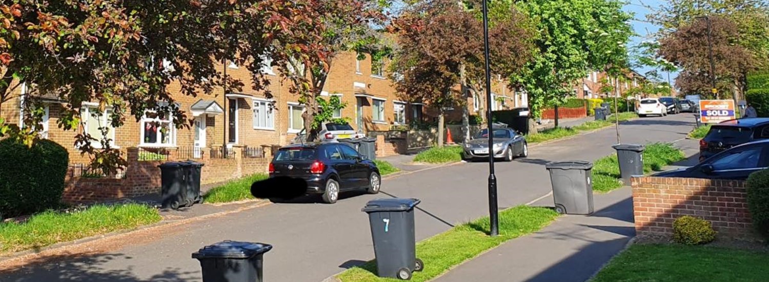 bins out on a suburban street