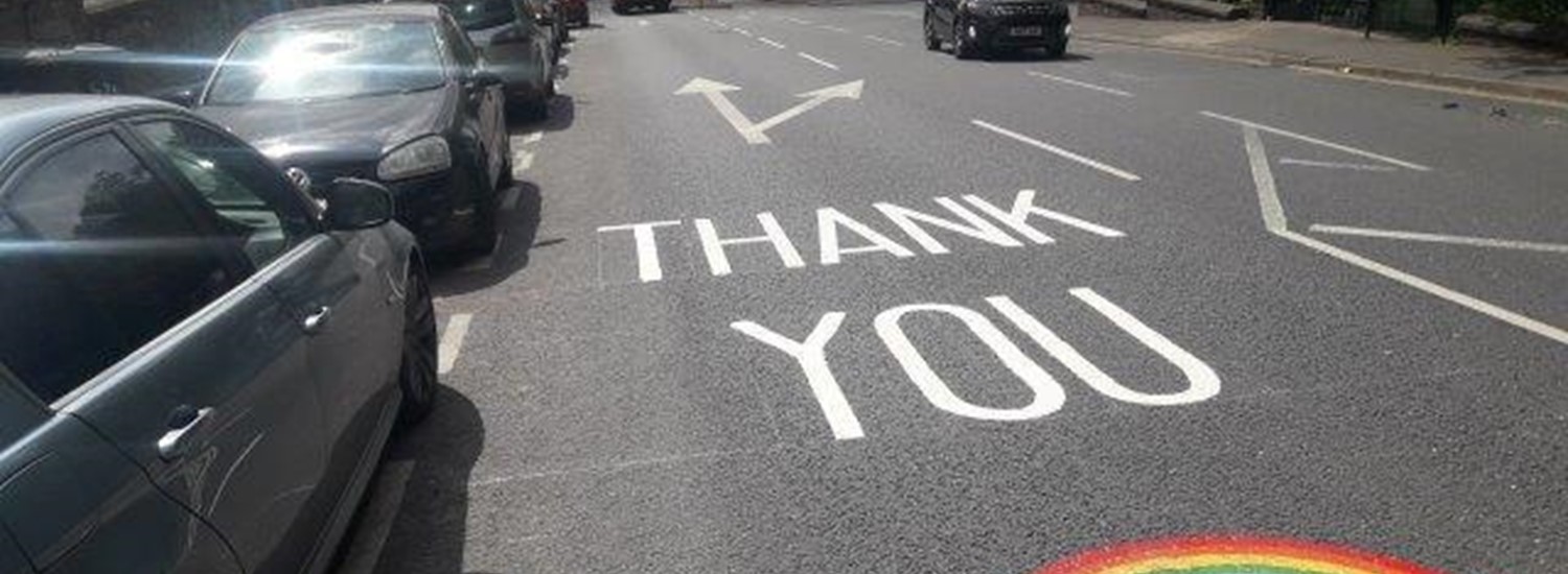 Thank you and rainbow painted on road outside hospital