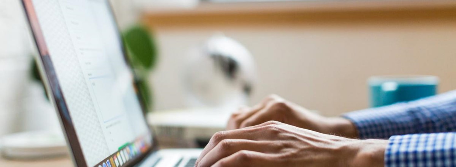 hands typing on a laptop