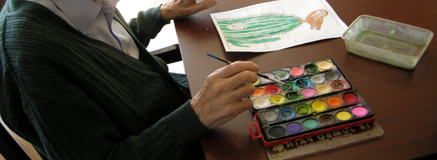 Older person doing crafts at a table