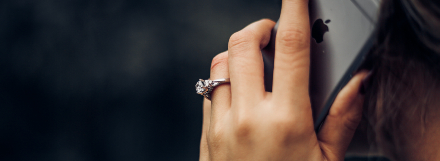 close up of hand holding a phone to an ear