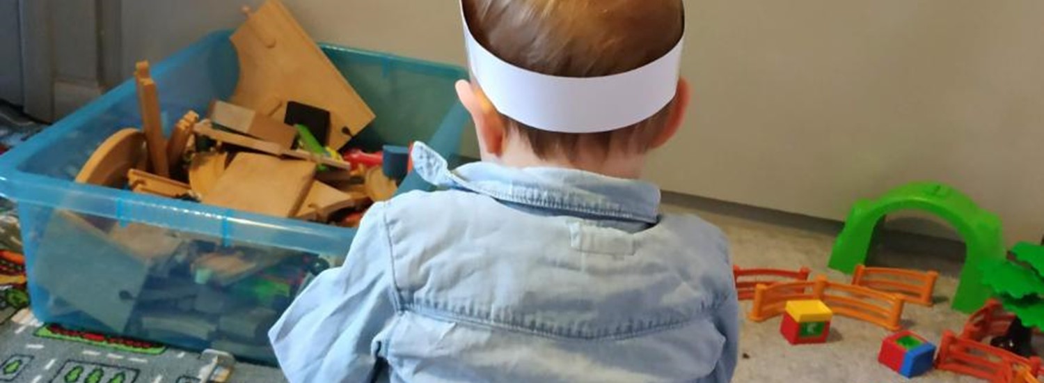 Toddler playing with toys on the floor