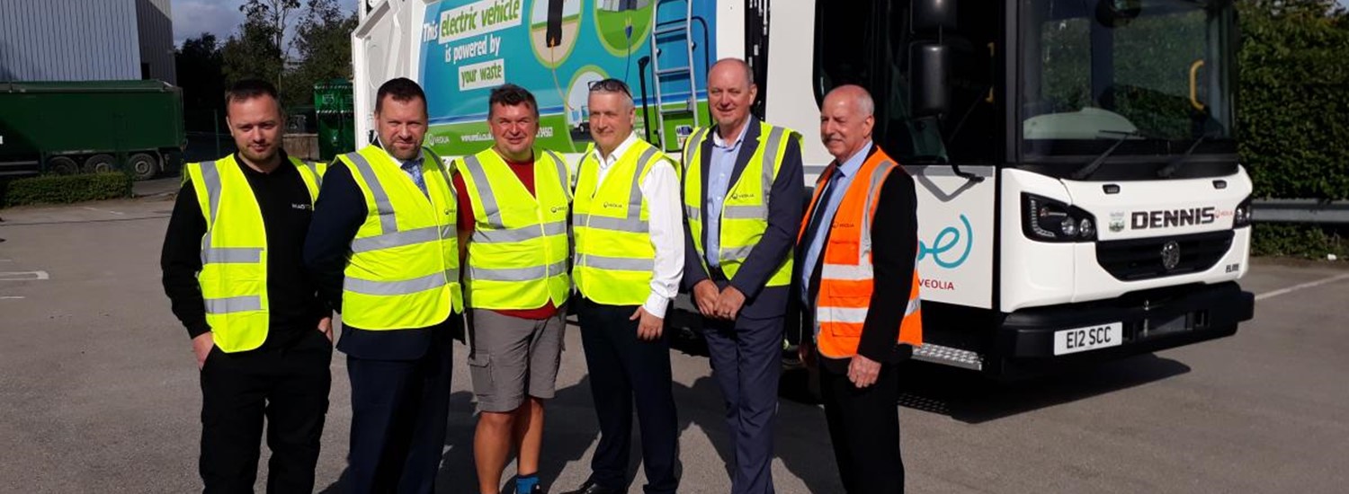 Electric bin lorry and workers